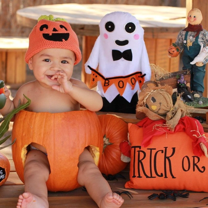 Baby in Pumpkin Seat with Halloween Decorations