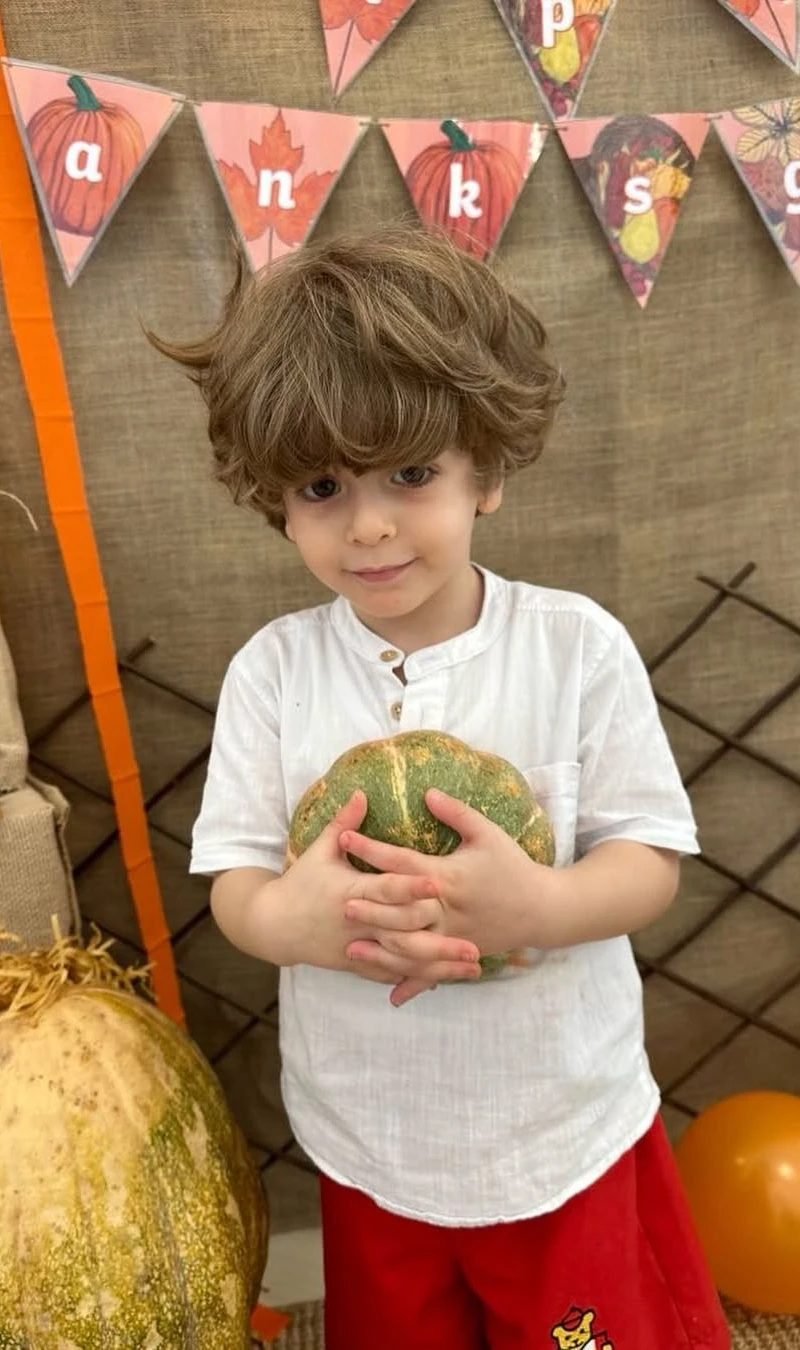 Charming Boy in Classic White Henley at Thanksgiving Setup