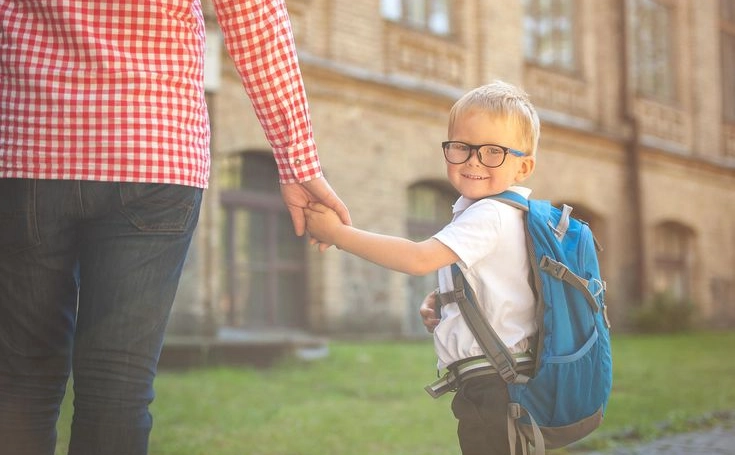 Child Holding Parent's Hand on First Day