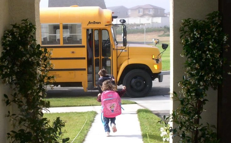 Child Running to School Bus on First Day