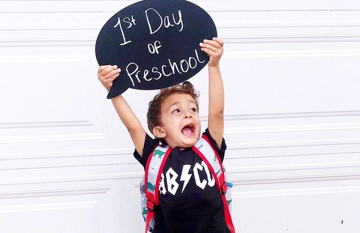 Excited Preschooler with Speech Bubble Sign