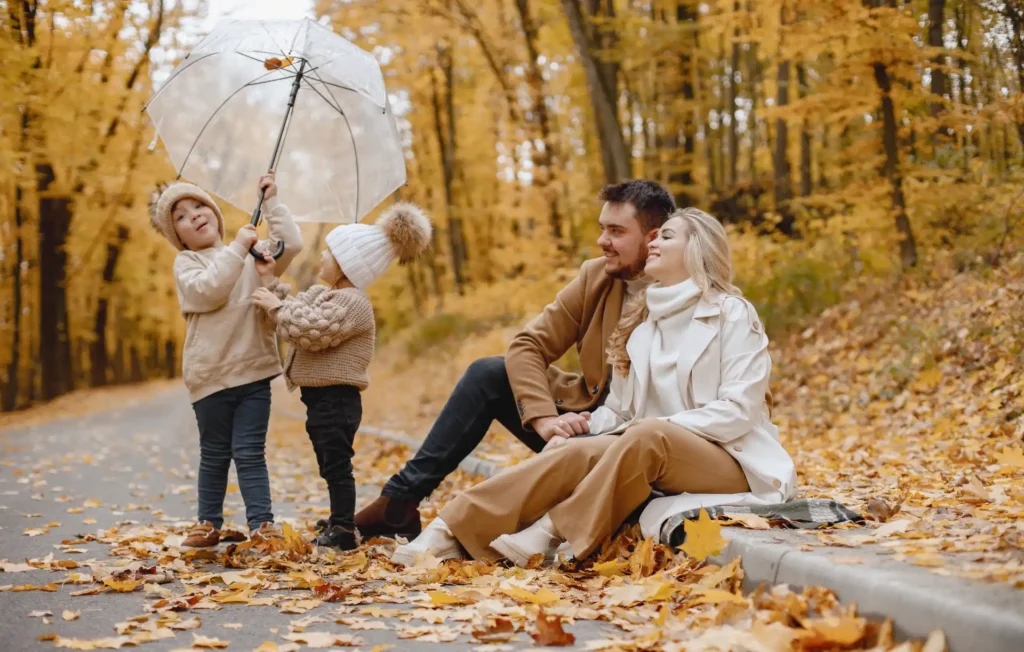 Fall Family Roadside Portrait with Neutral Tones and Umbrella