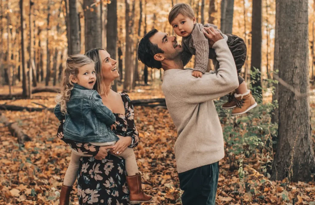 Family of Four Among the Falling Leaves