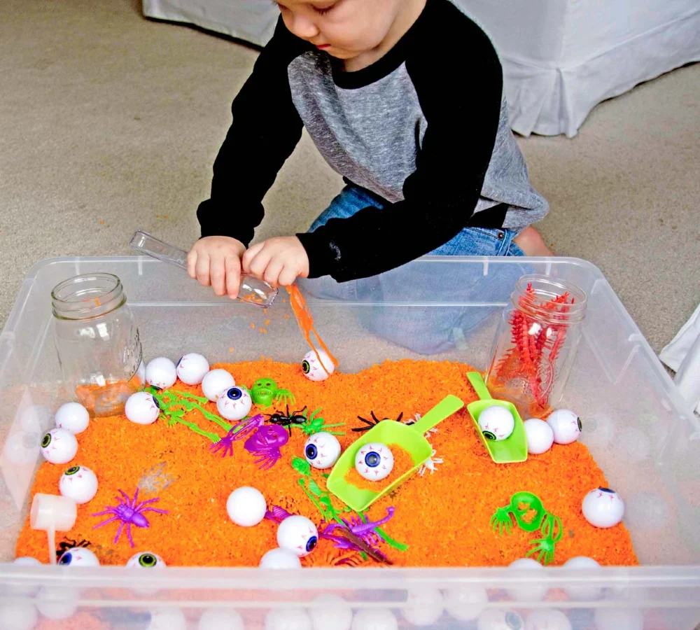 Halloween Sensory Bin with Orange Rice