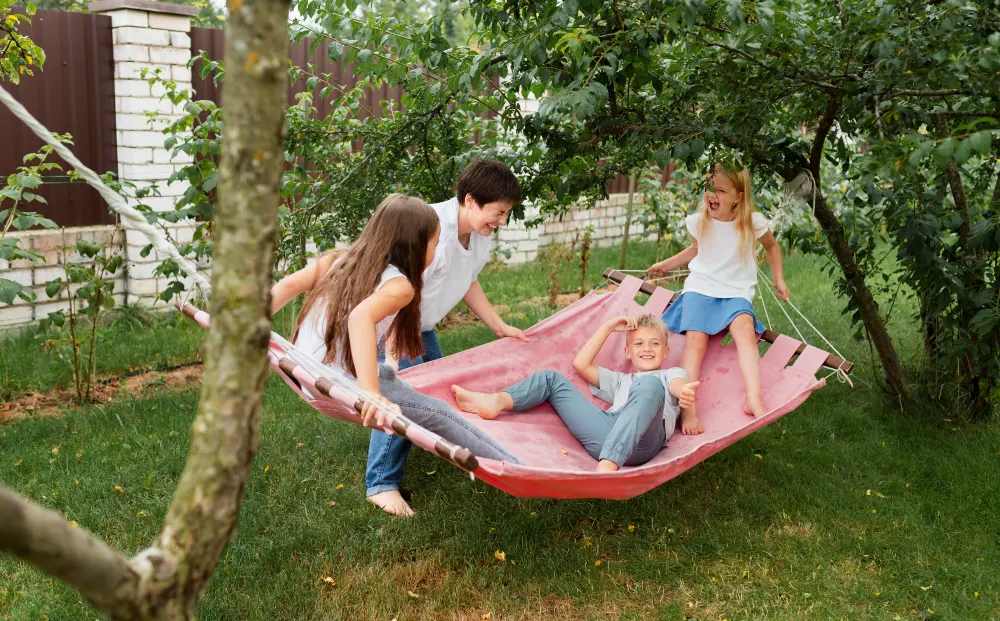 Kids Piling into Backyard Hammock