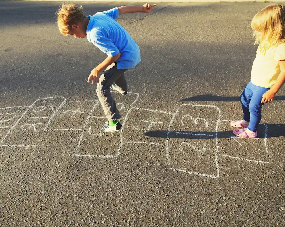 Kids Playing Hopscotch on Pavement
