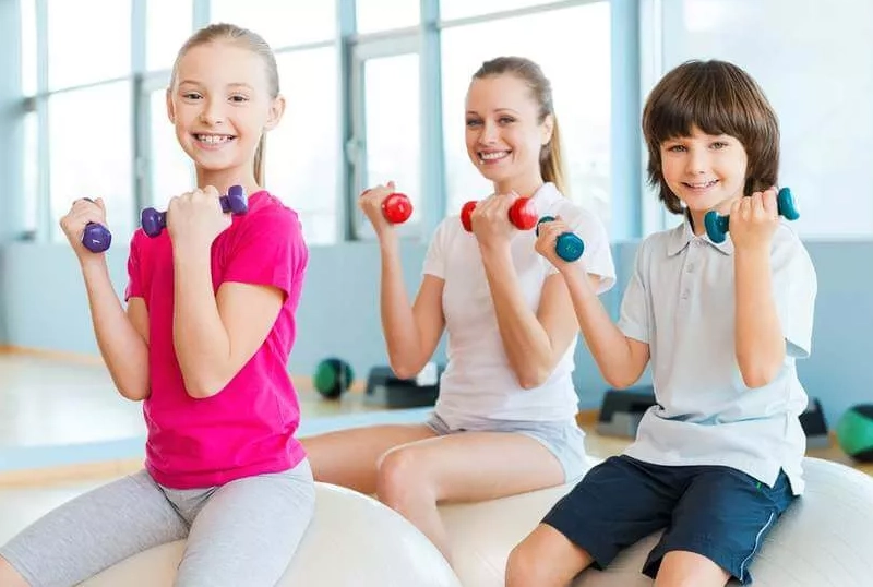 Kids Working Out with Dumbbells Indoors